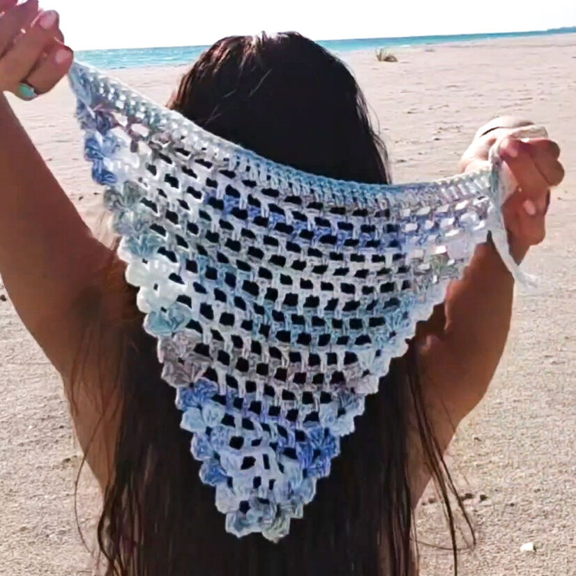A free crochet pattern for the Breezy Bandana. It features a boho chic design with a shell border.