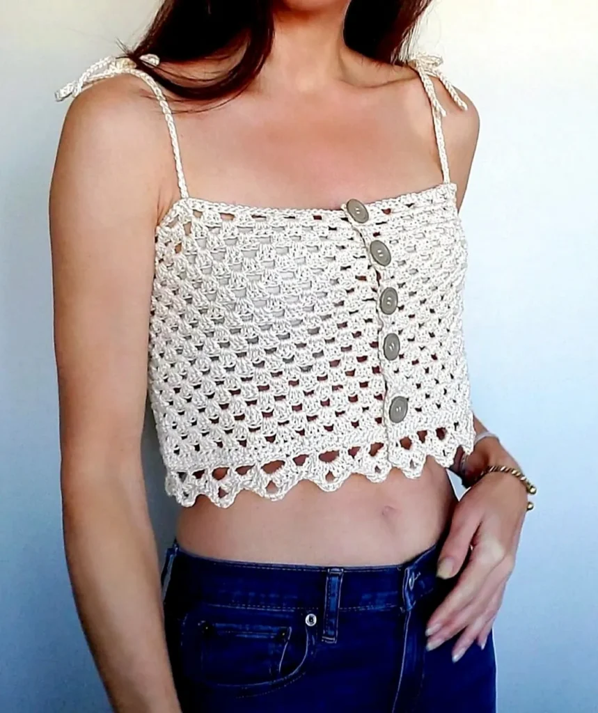 A free crochet pattern for a Bohemian style top that features the granny square stitch and is in an Ivory color.