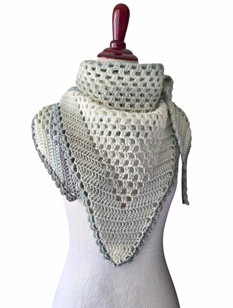 Free crochet pattern for an easy lightweight triangle spring shawl in pastel colors styled on a mannequin