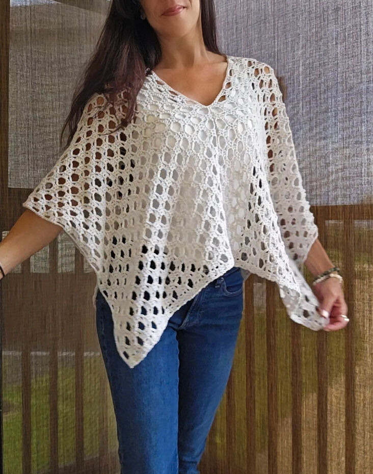 The Sierra Sun Poncho crochet pattern that features an open stitch design.