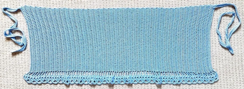 The crochet wrap skirt laid flat to show how to sew the side ties on.