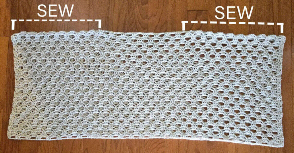 Sierra Sun Poncho crochet pattern laid out flat to show how to sew the shoulder seams.
