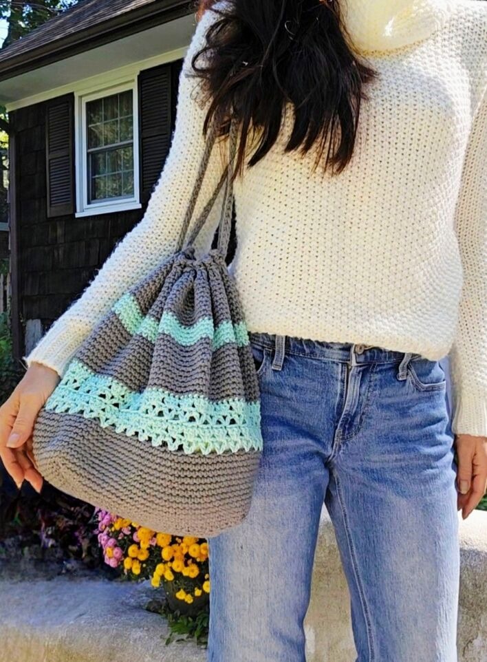A handmade, textured crochet project bag with an easy to cinch drawstring top.