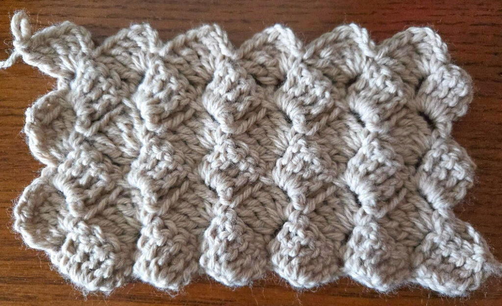 It shows what the crochet scarf should look like after completing several rows.